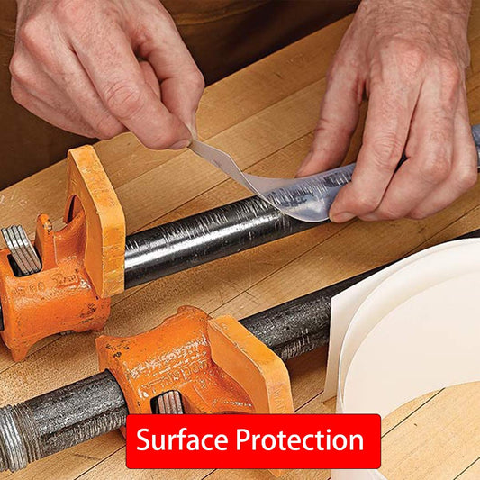 Hands applying UHMW tape to a metal clamp surface