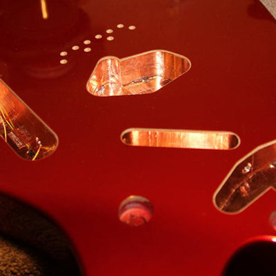 Copper foil lining the pickup cavities of an electric guitar